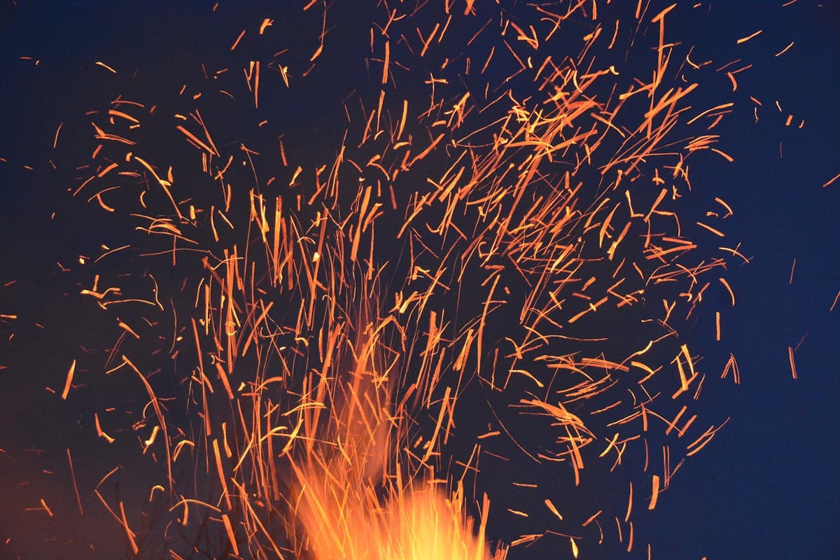 Large rectangular fire pit at full flame in evening light