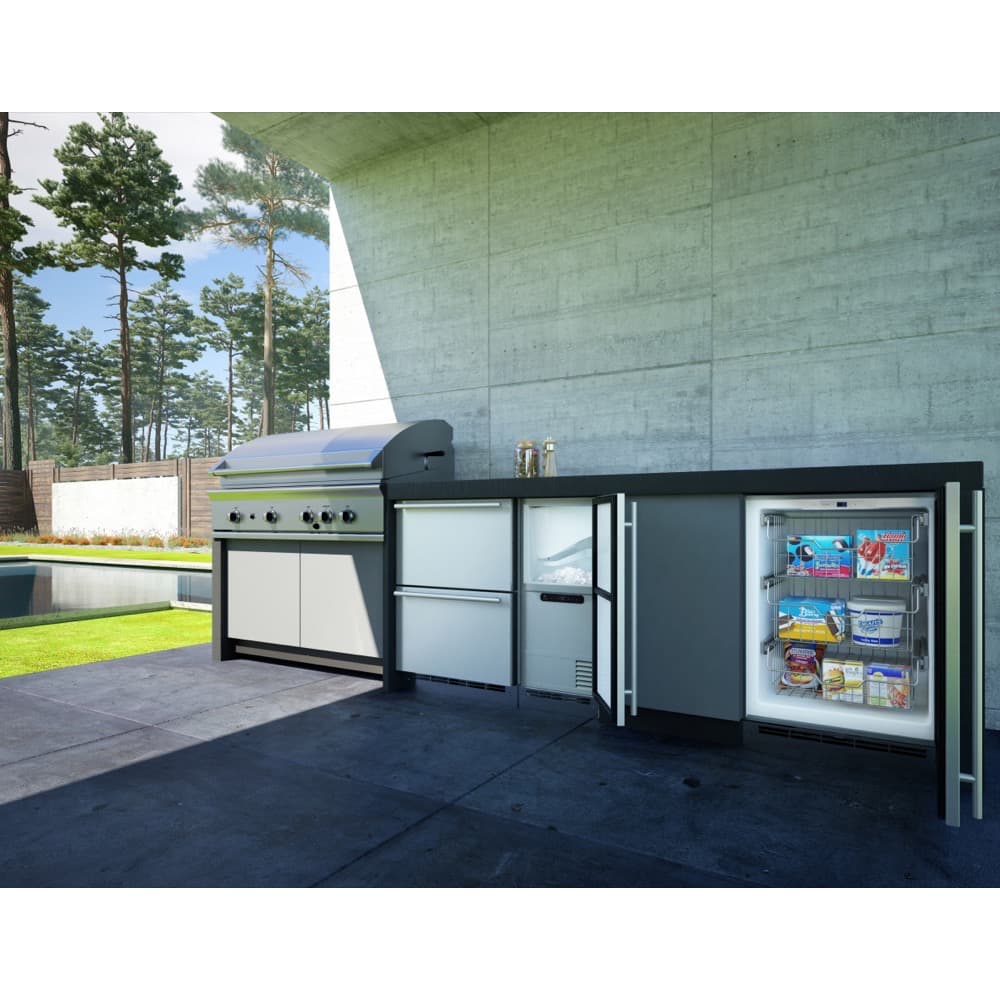 U-Line 15-inch outdoor-rated built-in clear ice maker installed in a stainless outdoor kitchen island, ice bin open, at dusk.